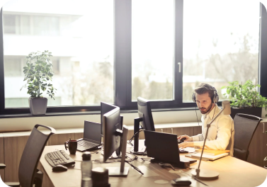 Individual working on a laptop in a sunny office